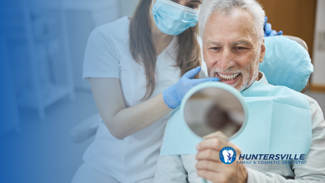 dental provider and patient admiring results of dental implant services in Huntersville NC